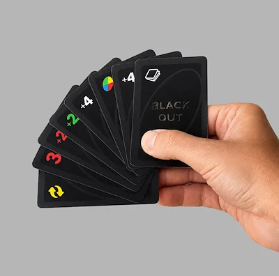 Hand holding UNO Blackout edition cards fanned out